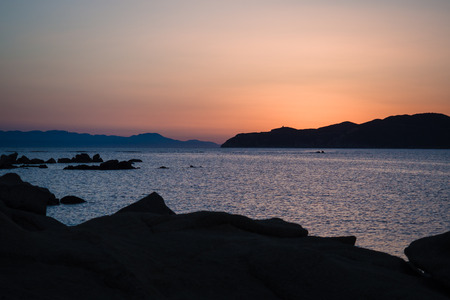 The sun sets over the sea in the wonderful Sardinia, Italy.の写真素材