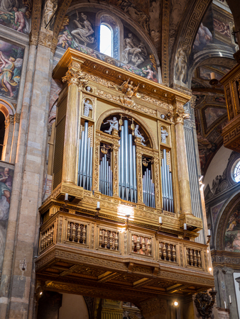 Parma, Italy - April 8, 2018: Magnificent golden and inlaid organ inside the cathedral.のeditorial素材