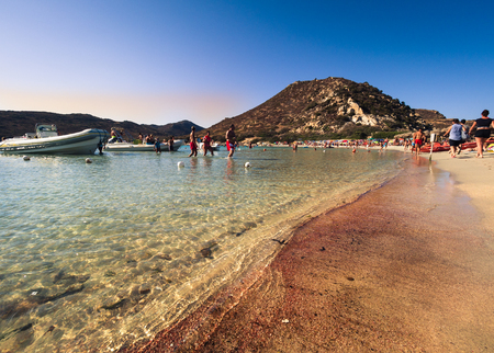 Sardinia, Italy - August 22, 2017: The characteristic red beach of Punta Molentis in Sardinia. The color is caused by the fragmentation of red coral.のeditorial素材