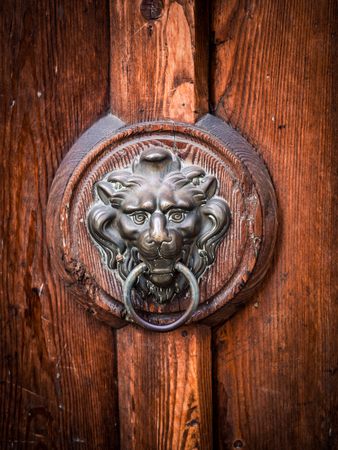 Antique door knocker shaped like a lion's head.の写真素材