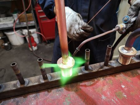 Detail of soldering of brass fittings on copper pipe.の写真素材
