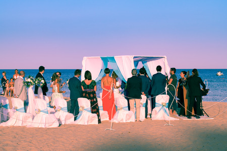 Sardegna, Italy - August 22, 2016: Wedding celebrated on the beach by the sea at sunset.のeditorial素材