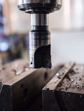 Detail of the tool of a milling cutter in an industrial workshop.