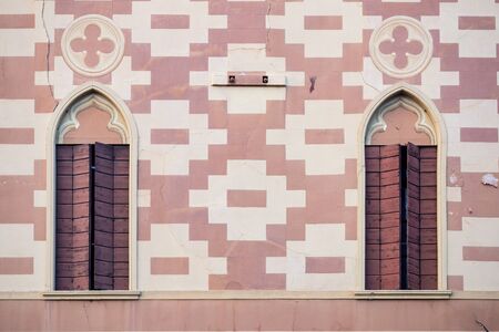 Facade of an Italian Renaissance palace with typical shaped windows.