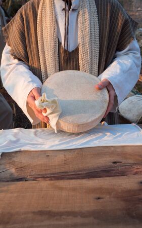 Selling cheese at a market stall in a rural area.の写真素材