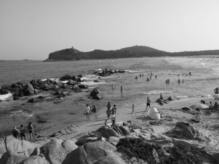 Sardinia, Italy - August 7, 2019: Tourists and bathers on the sand and rock beaches typical of Sardinia.の写真素材
