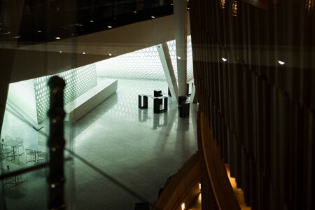 Some black modern furniture in a large building modern building