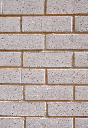 Wall of decorative white bricks with yellow fugueの写真素材