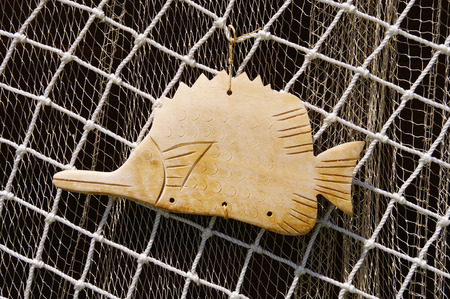 Two fishing nets and wooden fish for decorationの写真素材