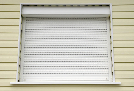 Window with white external blinds from american style houseの写真素材