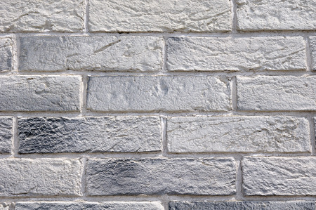 Slabs imitation bricks on wall closeup in sunny day