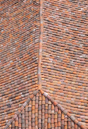 Old roof with colorful ceramic tiles in sunny dayの写真素材