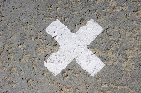 White ol sign cross on road in sunny dayの写真素材