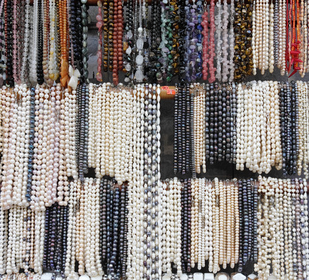 Stand with necklaces of pearls and semiprecious stonesの写真素材