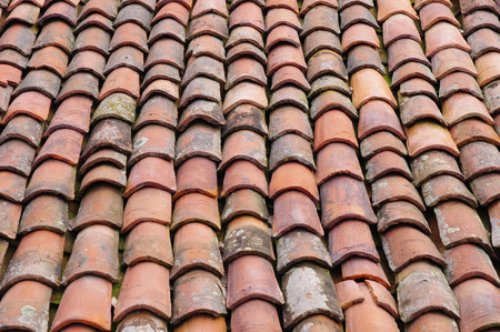Old roof with colorful ceramic tiles in sunny day