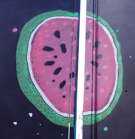 Drawing of watermelon on opening black doorの写真素材