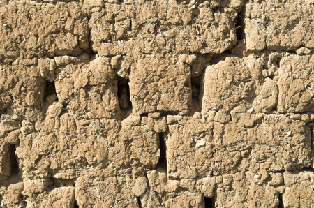 Old adobe wall closeup in sunny dayの写真素材