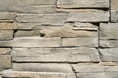 Cladding tiles imitating stones in sunny day