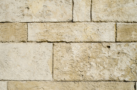 Old stone wall closeup  in sunny dayの写真素材