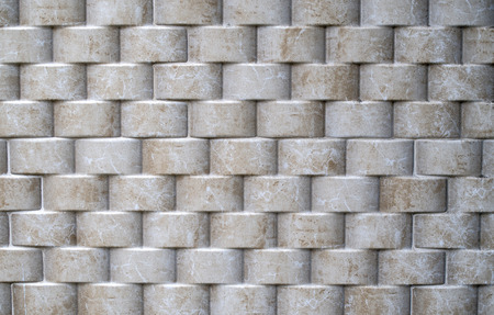 Decorative relief cladding slabs imitating cylinders on wall closeupの写真素材