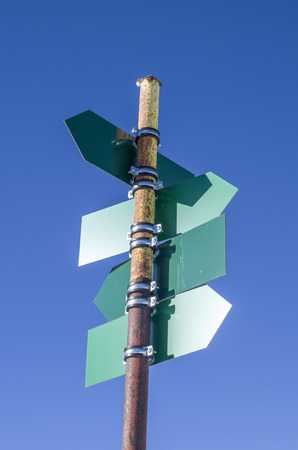 Blank green directional signs in blue skyの写真素材
