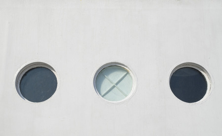 Three porthole of white sailing ship closeup の写真素材
