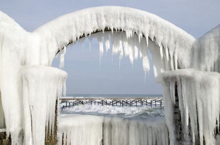 Icy arches from storm in winter on seashore in sunny day, Bulgariaの写真素材