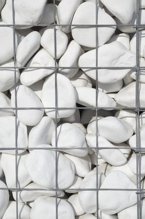 White stone in new iron mesh closeup  in sunny day
の写真素材