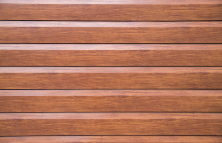 New decorative brown wall imitating wooden boards closeup