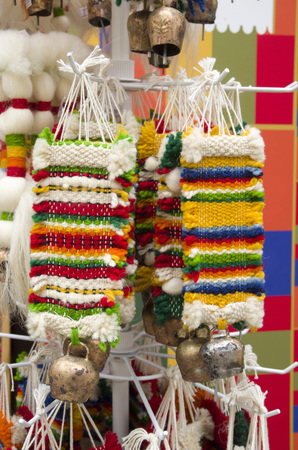 Colorful bulgarian woven souvenirs with a forged bell, Europeの写真素材