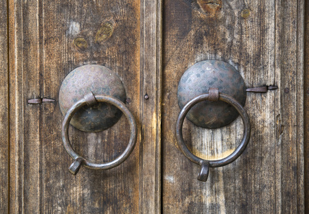 Two round doorknobs  on old wooden door , Bulgaria, Europeの写真素材