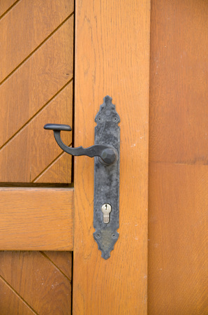 New black handle  on wooden door , Bulgaria, Europeの写真素材