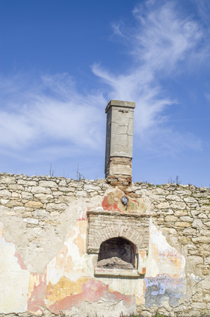Old wall with fireplace and chimmey in blue sky, Bulgariaの写真素材