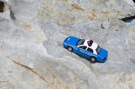 Toy blue police car on stone closeup in sunny dayの写真素材
