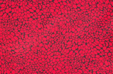 New silk fabric  with red oval shapes with black contour closeup