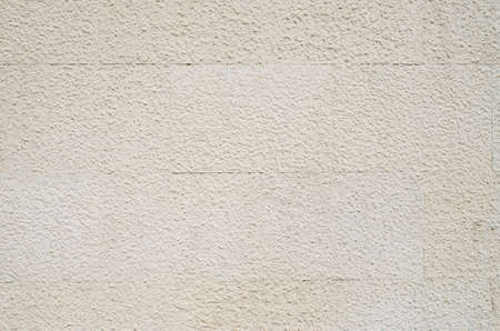 New ecru stone slabs on wall close up