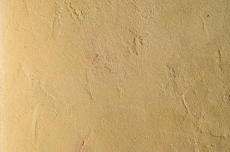 New yellow painted relief plaster om wall closeup
