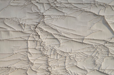Old cracked white plastic surface closeup