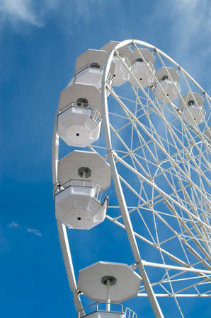 White Ferris wheel in the blue sky  with cloudsの写真素材