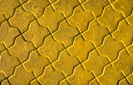 Yellow painted polygonal decorative tiles close upの写真素材