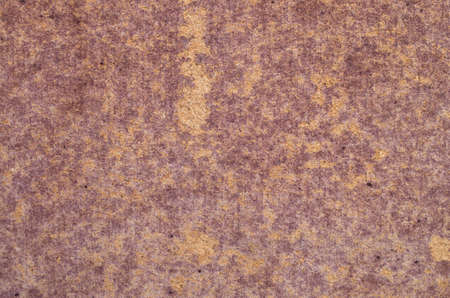 Old burgundy painted wood fiberboard closeupの写真素材