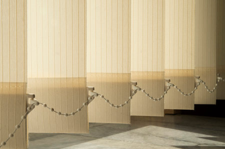 New light yellow vertical strip blinds close up in sunny dayの写真素材