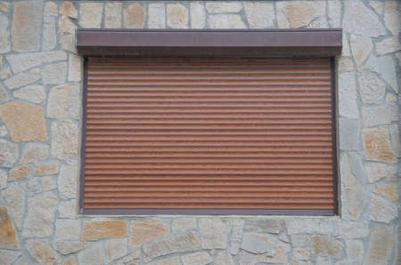 New external closed roller blind on a window close up