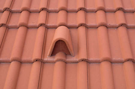 New concrete hooded vent tile pvc spigot on roof close upの写真素材