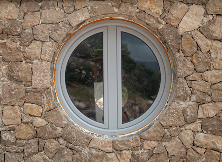New white round window  on stone wall closeup in Montenegro, Europeの写真素材