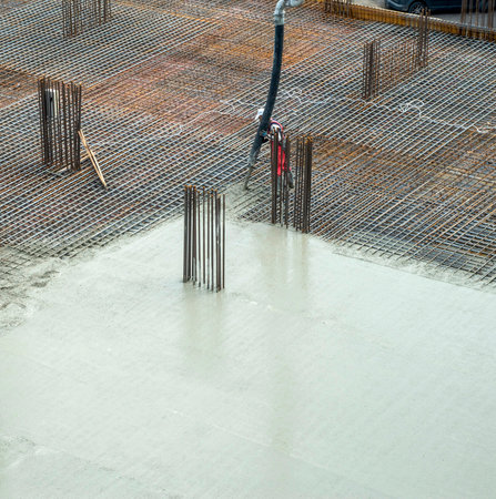 Concrete casting on reinforcing metal bars of a slab in new buildingの写真素材