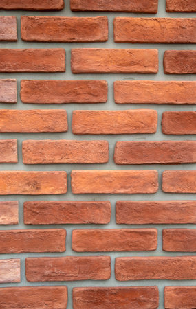 New decorative brick on gray background on wall close up