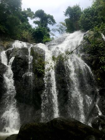 Scenic view at Argyle Falls (Roxborough, Caribbean island of Trinidad and Tobago): stunning waterfall with lush tropical greenery and gigantic rock formationsの写真素材
