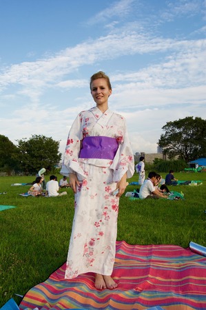 Matsuri festival with a picnic in Osaka in front of the city skylineの写真素材