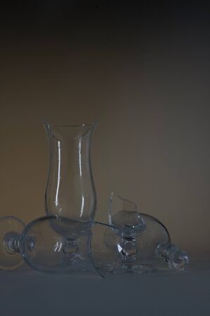 Dangerous still life with three empty modern broken / shattered glasses on a tableの写真素材